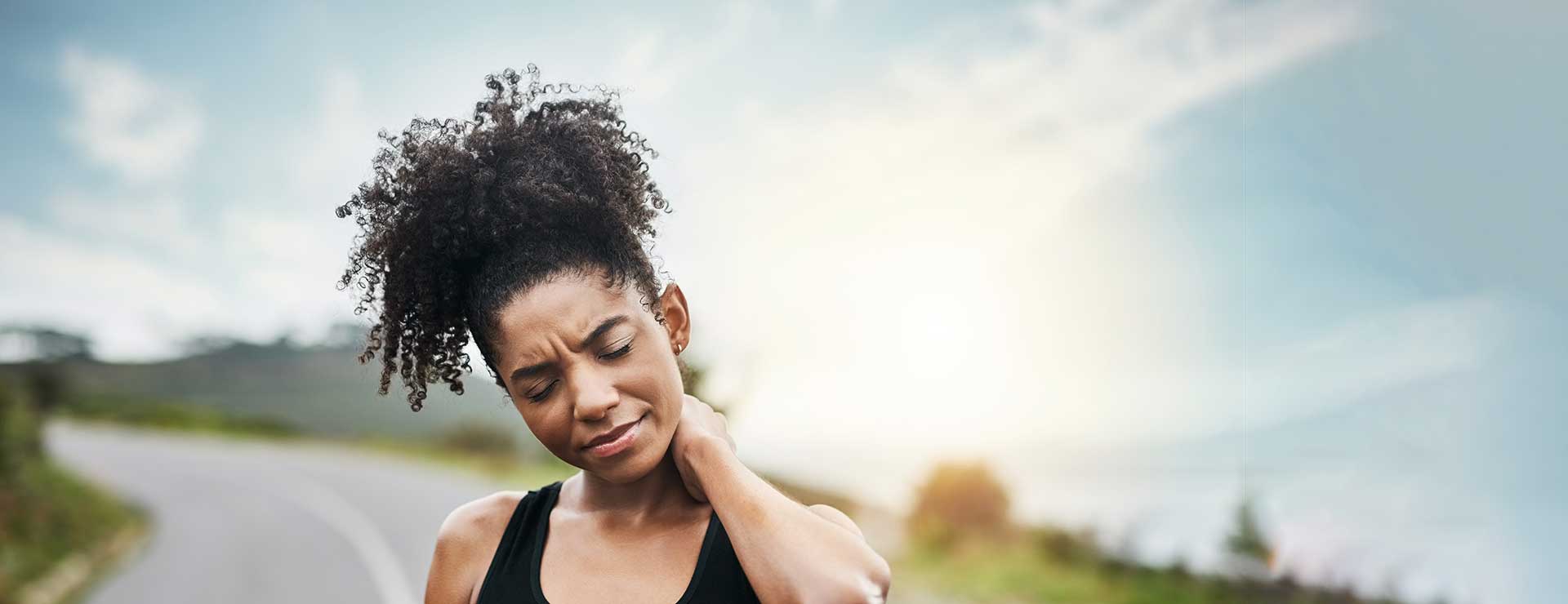 Woman rubs her neck