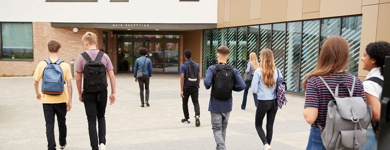 teens walk towards school