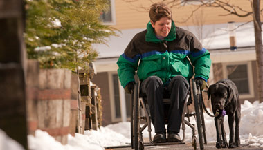 Person in a wheelchair walking their dog