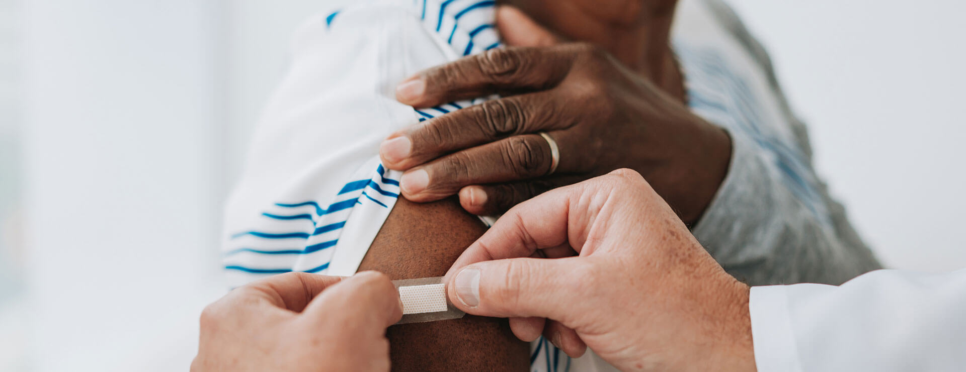 provider puts bandaid on arm