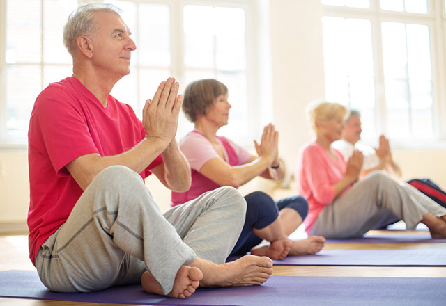 Senior adults practicing yoga.