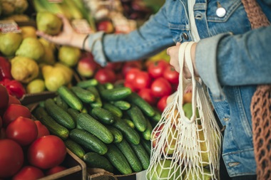 Woman buying healthy fruits and vegetables