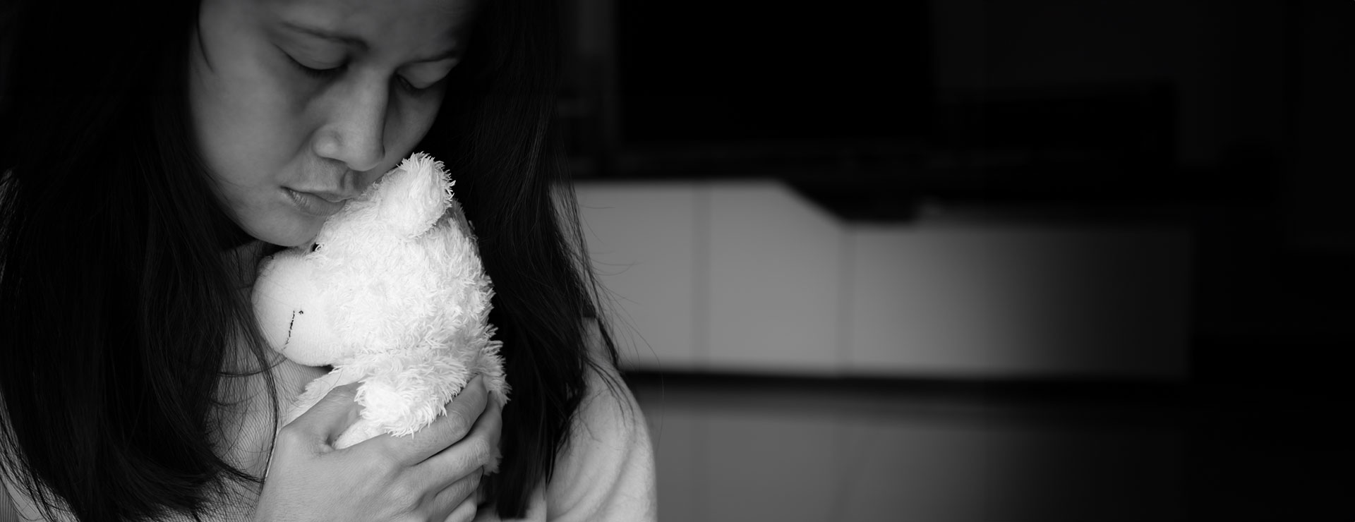 woman holds teddy bear