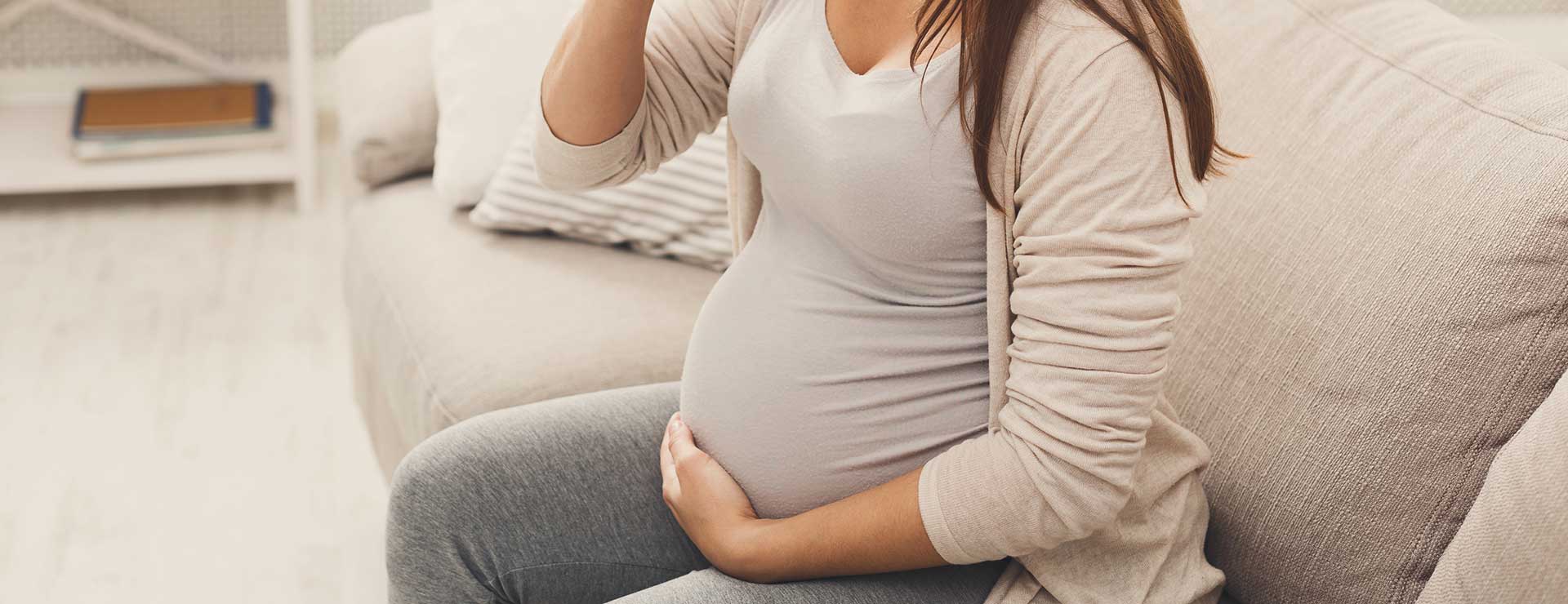 Pregnant woman sitting on the sofa