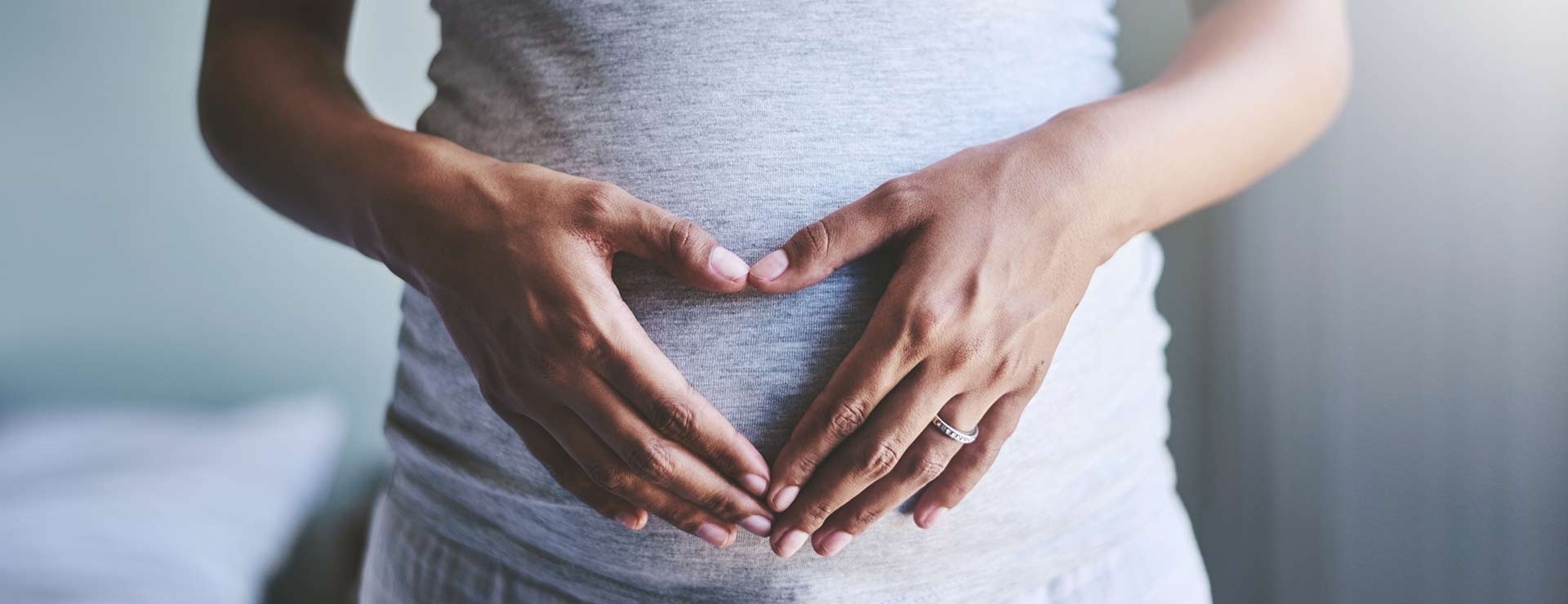 Pregnant woman with a hand on her belly