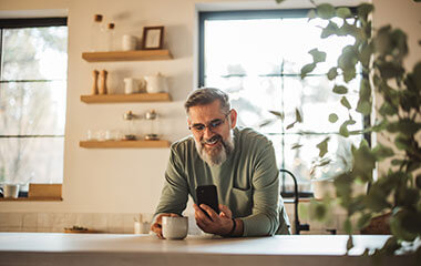 a man drinks coffee as he considers benign prostate problems