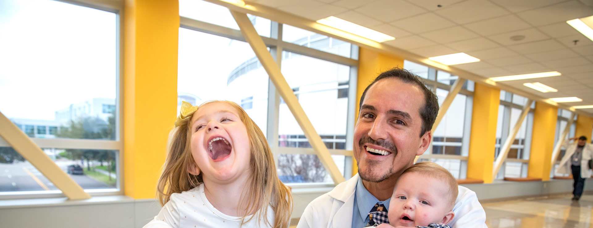Neonatologist Prem Fort, M.D., with Hannah and Joshua, siblings who were both patients in the NICU at Johns Hopkins All Children’s.