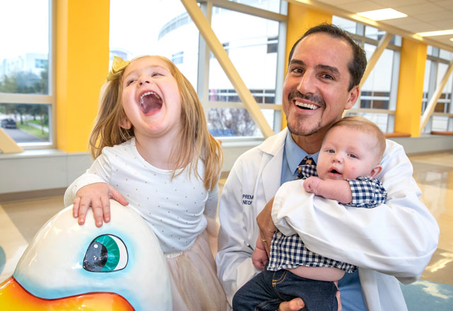 Neonatologist Prem Fort, M.D., with Hannah and Joshua, siblings who were both patients in the NICU at Johns Hopkins All Children’s.