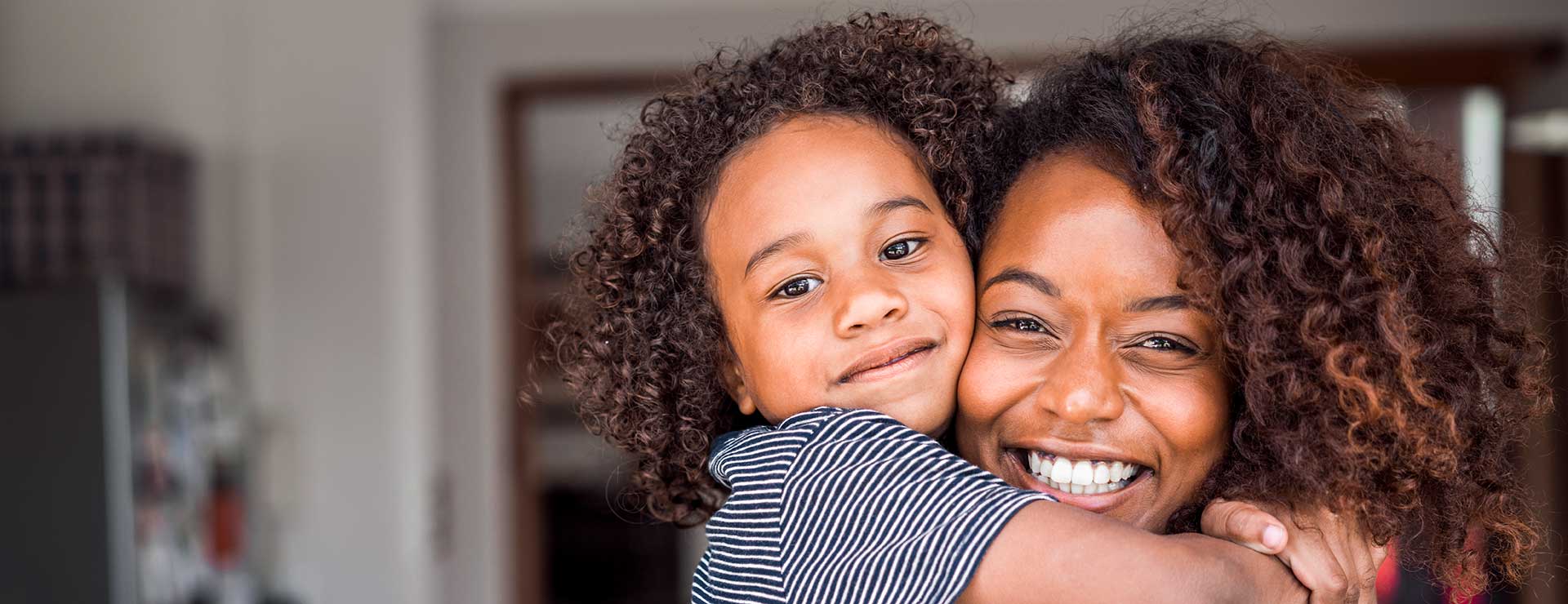 A mother and child embrace.