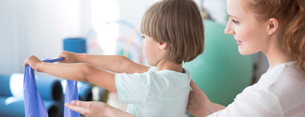 Physical therapist working with a child to correct scoliosis