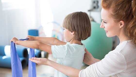 Physical therapist working with a child to correct scoliosis