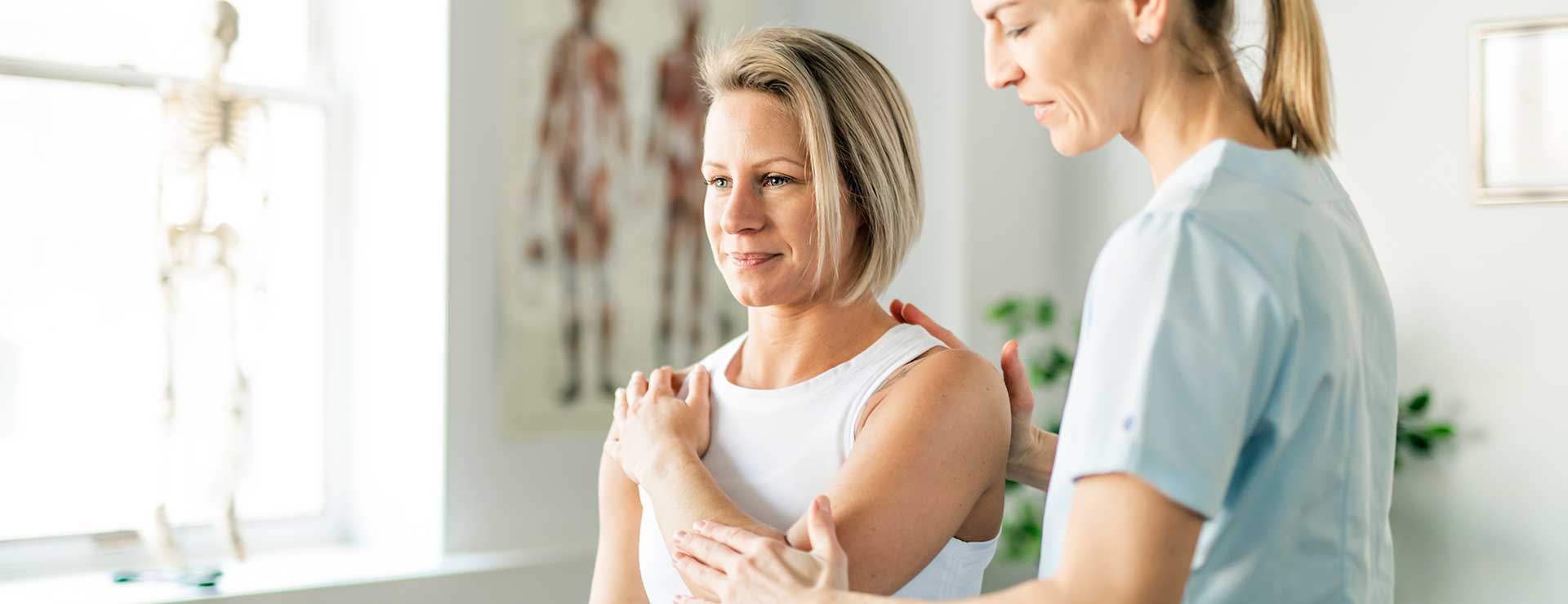 Medical professional examining patient's shoulder