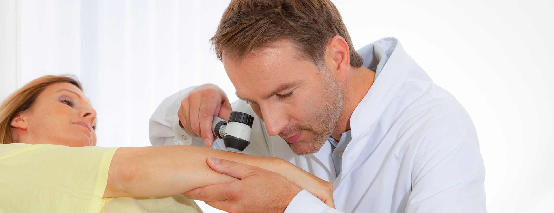 Doctor checks patient's skin