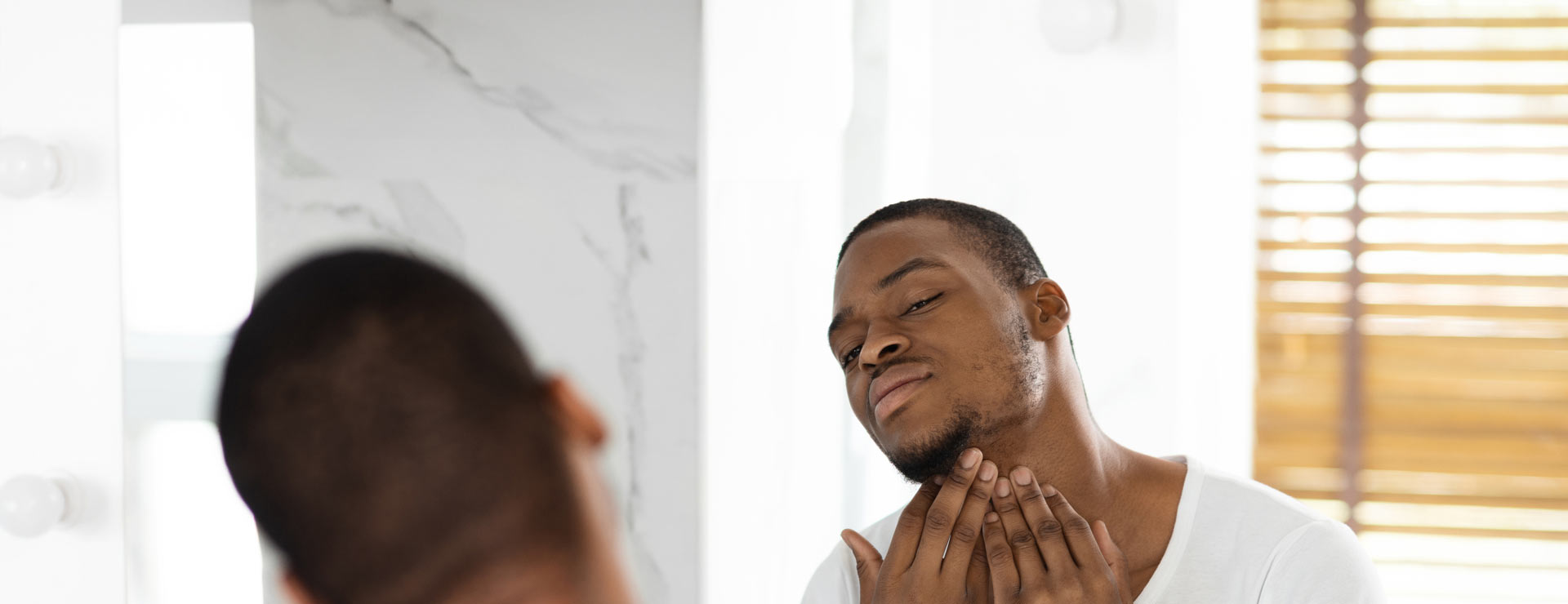 Man checking his chin for ingrown hairs