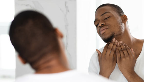 Man checking his chin for ingrown hairs
