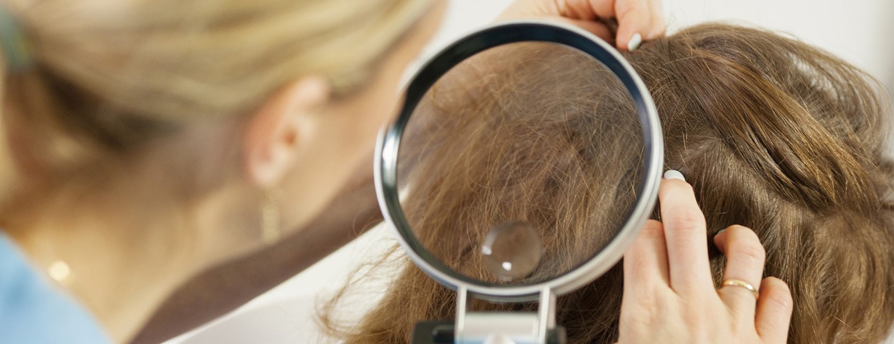Healthcare provider checking a child's head for lice