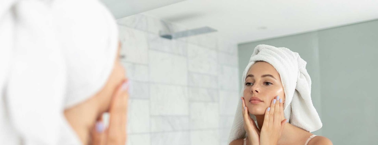 woman practicing proper skin care habits