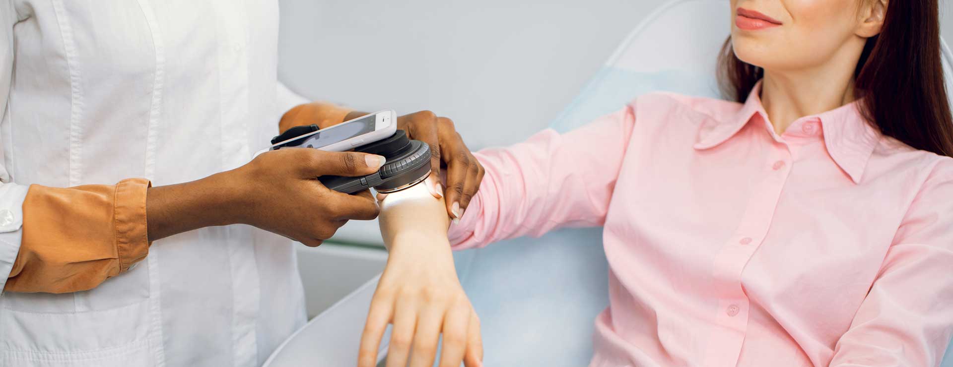 Dermatologist examines a patient's moles