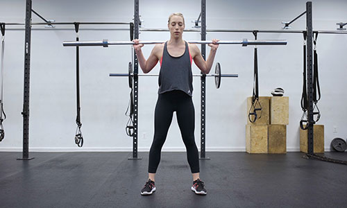 A woman lifts weights