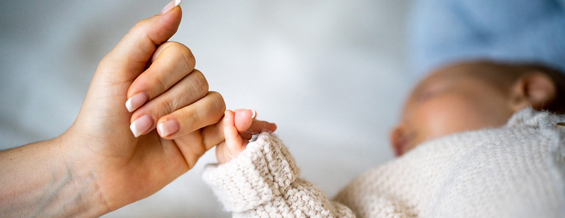 Mother holding her baby's hand