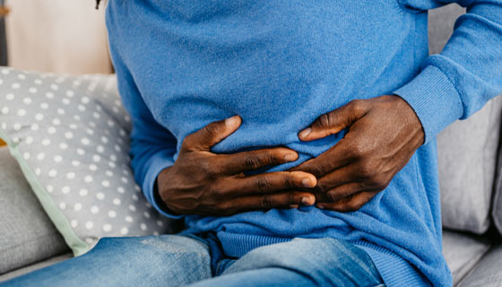 Person holding their stomach in pain