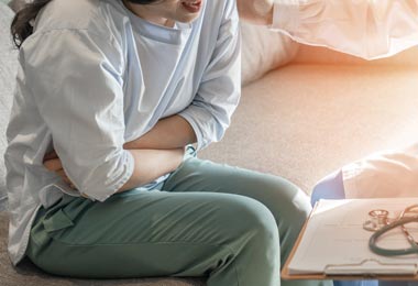 Woman experiencing abdominal pain