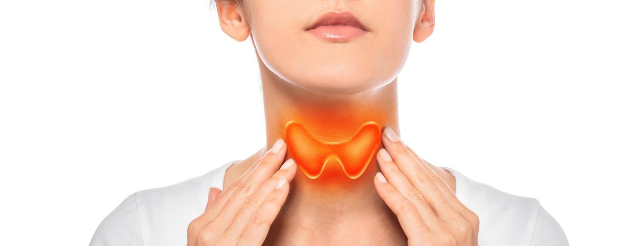 Person pointing out thyroid in their neck