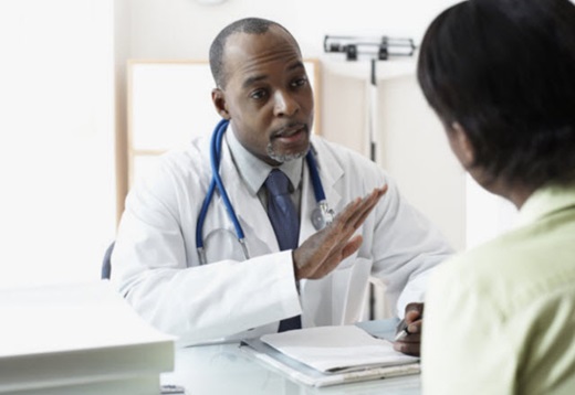 male doctor speaking to female patient