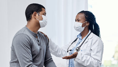 Doctor discussing care with young male patient