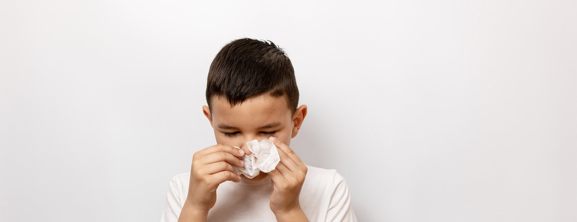 Child blowing nose.