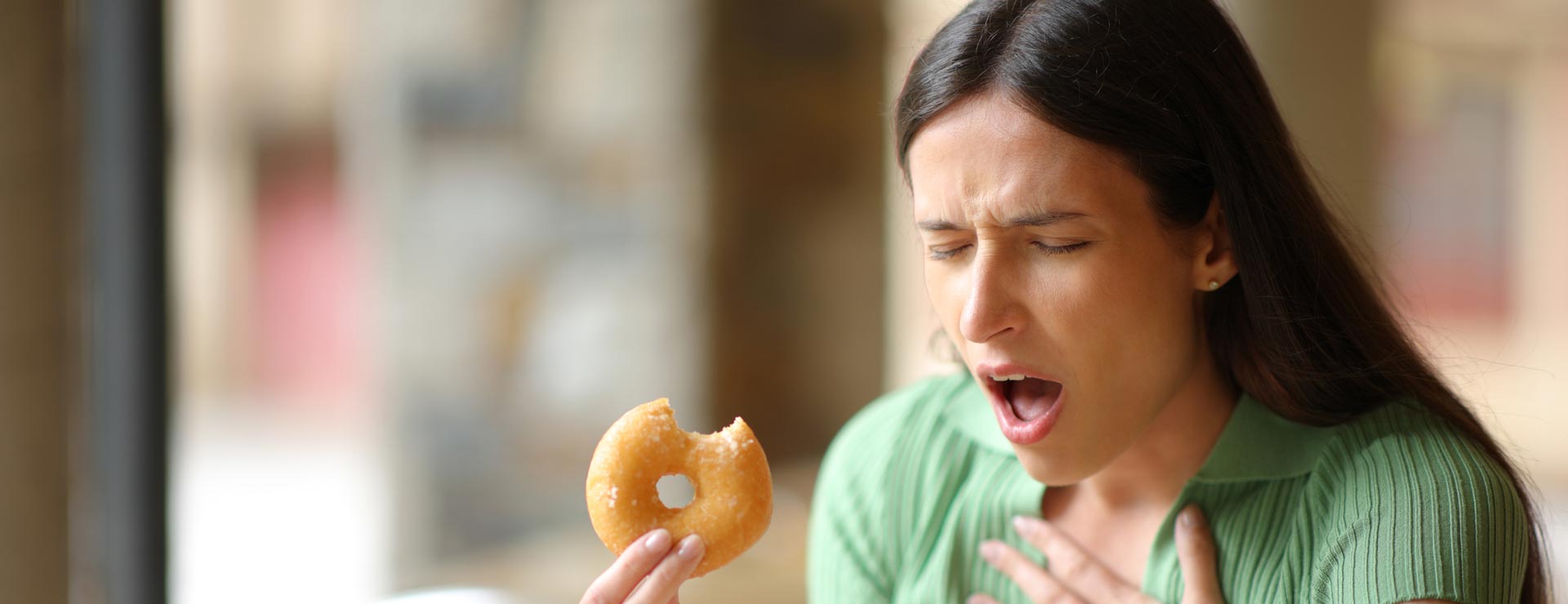 Woman choking on a donut
