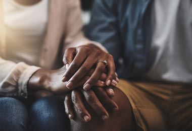 Married couple holding hands