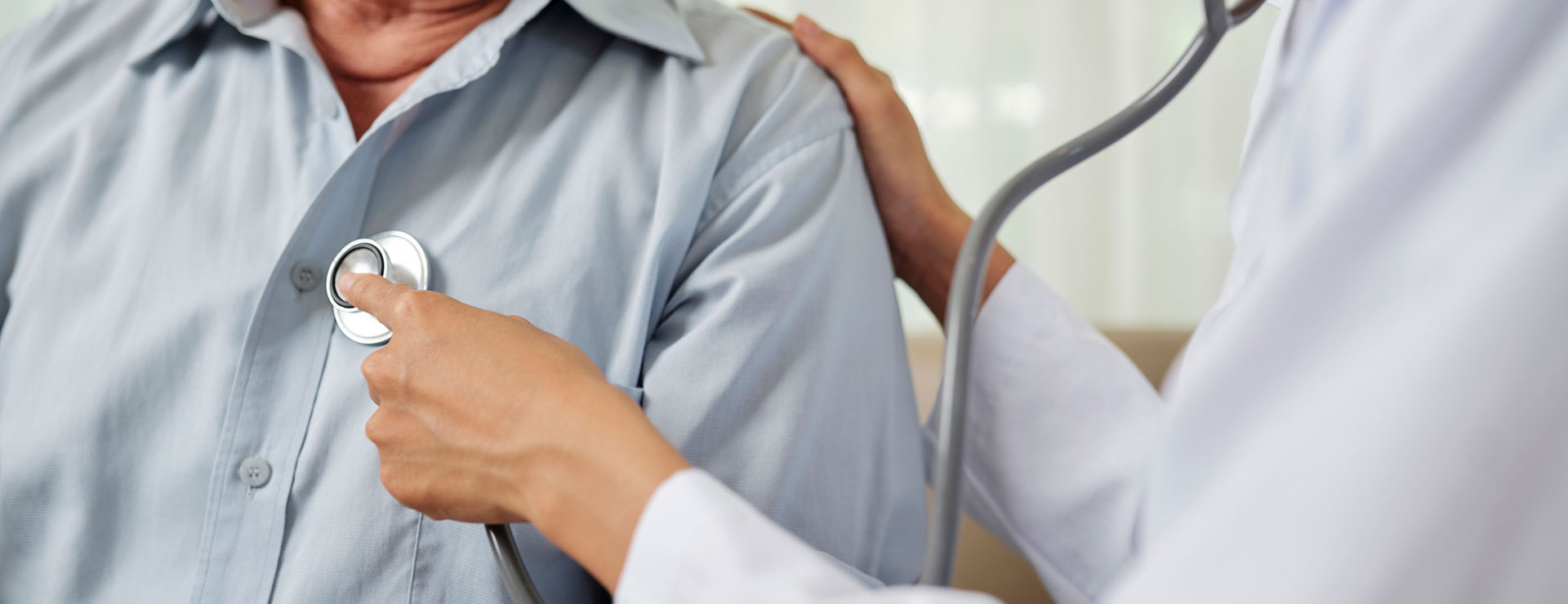 a doctor using a stethoscope on a patient