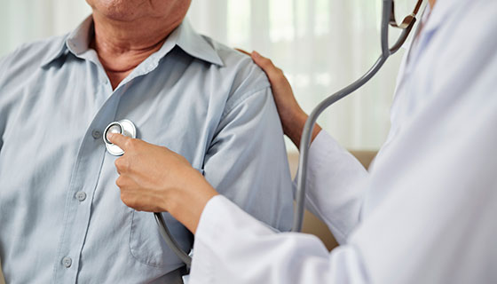 a doctor using a stethoscope on a patient