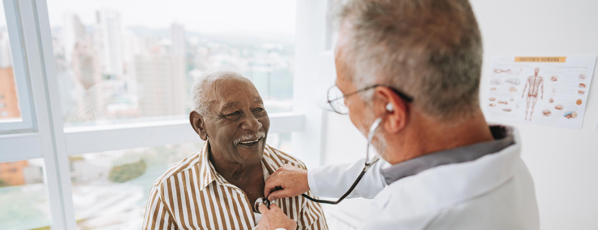 Older male patient getting his heart checked by a doctor