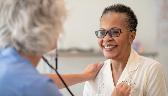 Older woman getting her heart checked by a doctor