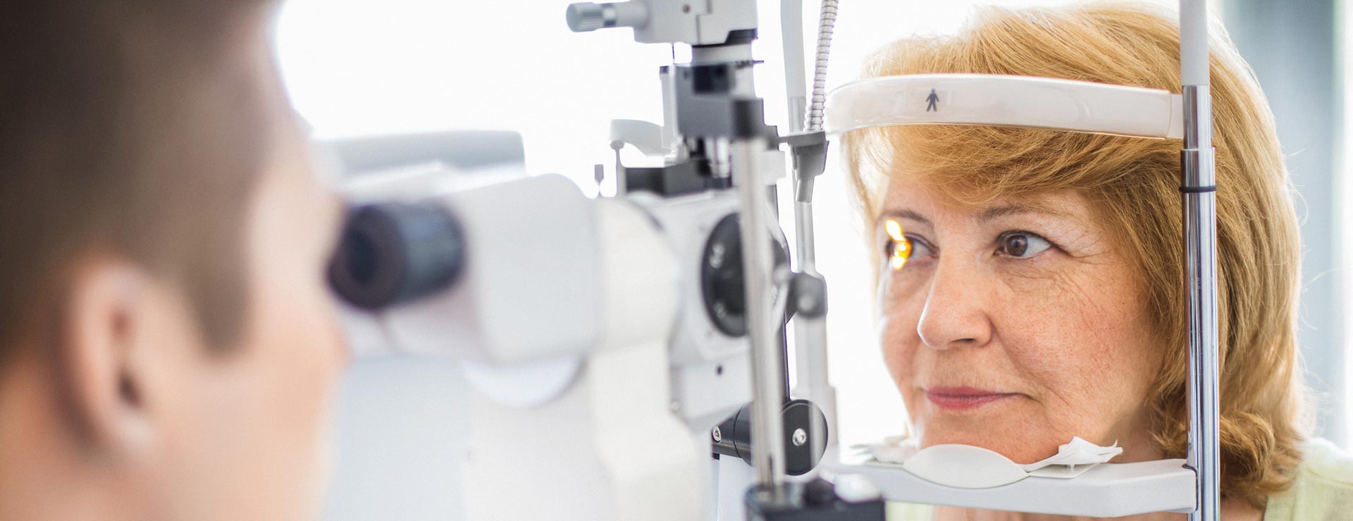 Older woman getting eye treatment