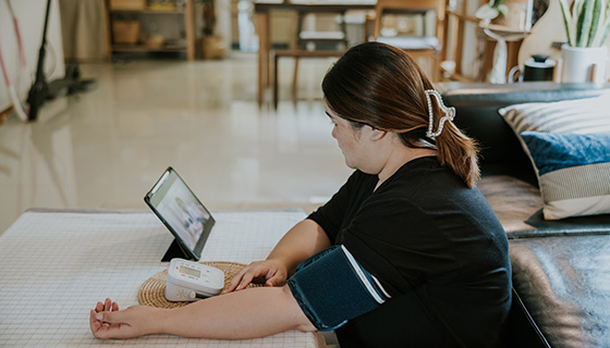 A woman monitoring her blood pressure