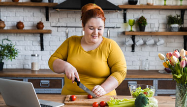 Overweight woman preparing vegetables