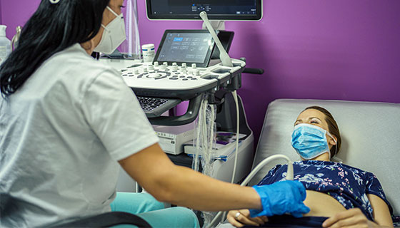 tech performs ultrasound on patient
