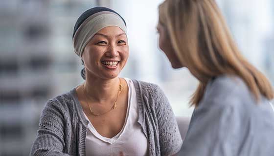 Woman with cancer talking to her doctor.