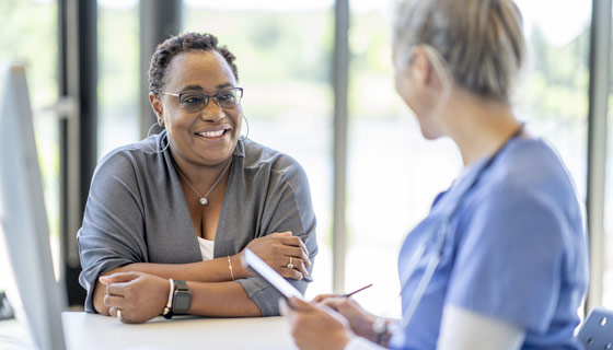 Older woman speaking with her doctor in doctors office