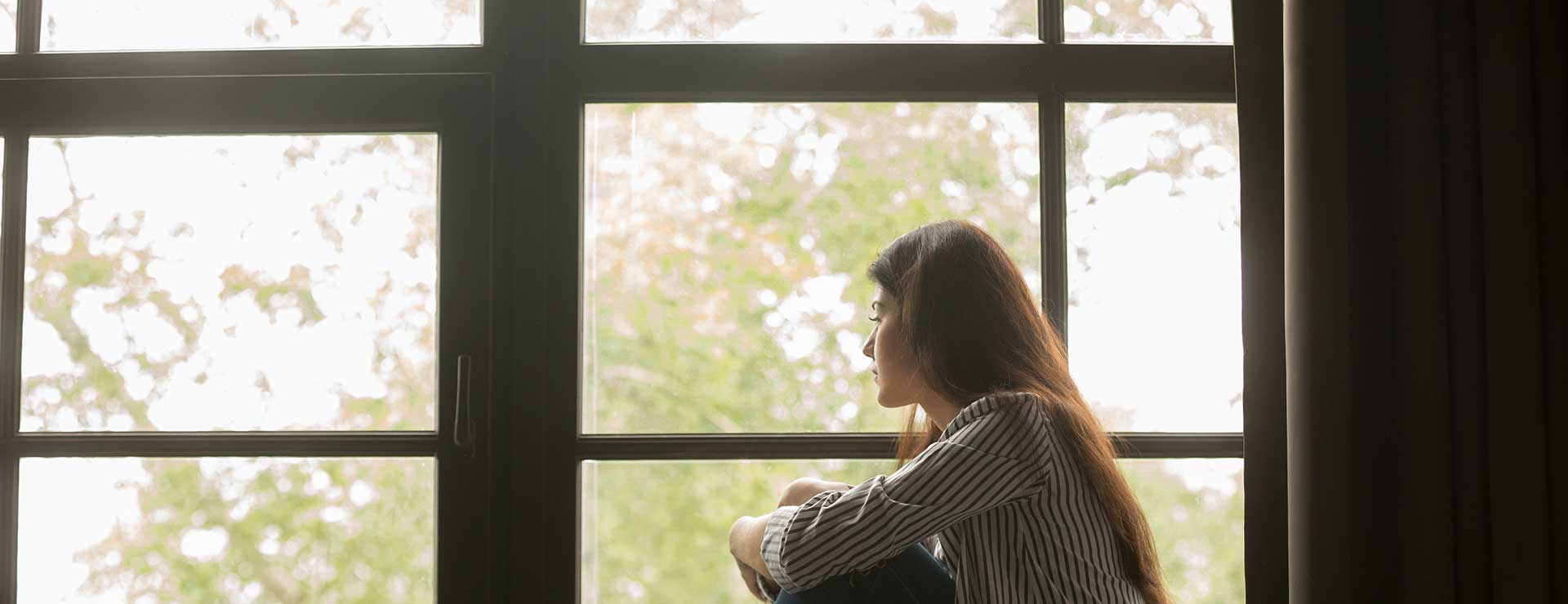 woman looking out window