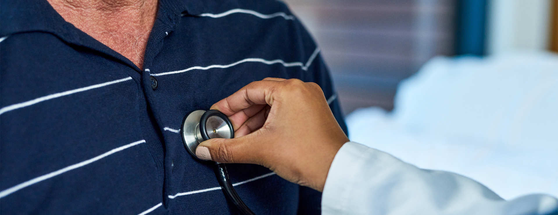 tricuspid valve replacement and repair - doctor listening to patient's chest with stethoscope