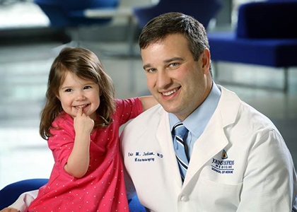 Dr. Jackson and a young patient smiling together