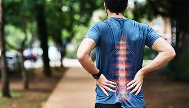man running holding his spine