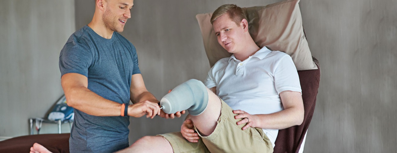 A man with an amputated leg does exercises with a physical therapist 