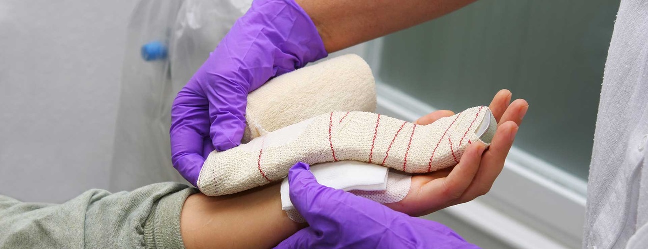 Nurse changing a bandage on a patient after carpal tunnel syndrome operation