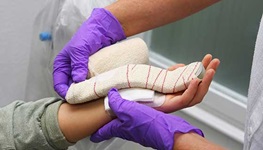 Doctor applying bandage after a carpal tunnel release surgery
