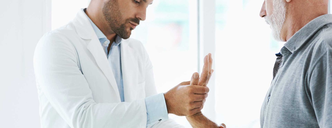 Doctor examining a patient's hand.